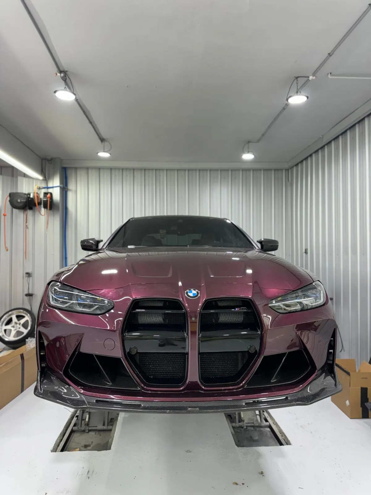 Purple G82 M4 fitted with carbon kidney grilles, carbon front ducts, and a carbon front lip for a sharper OEM-plus look.